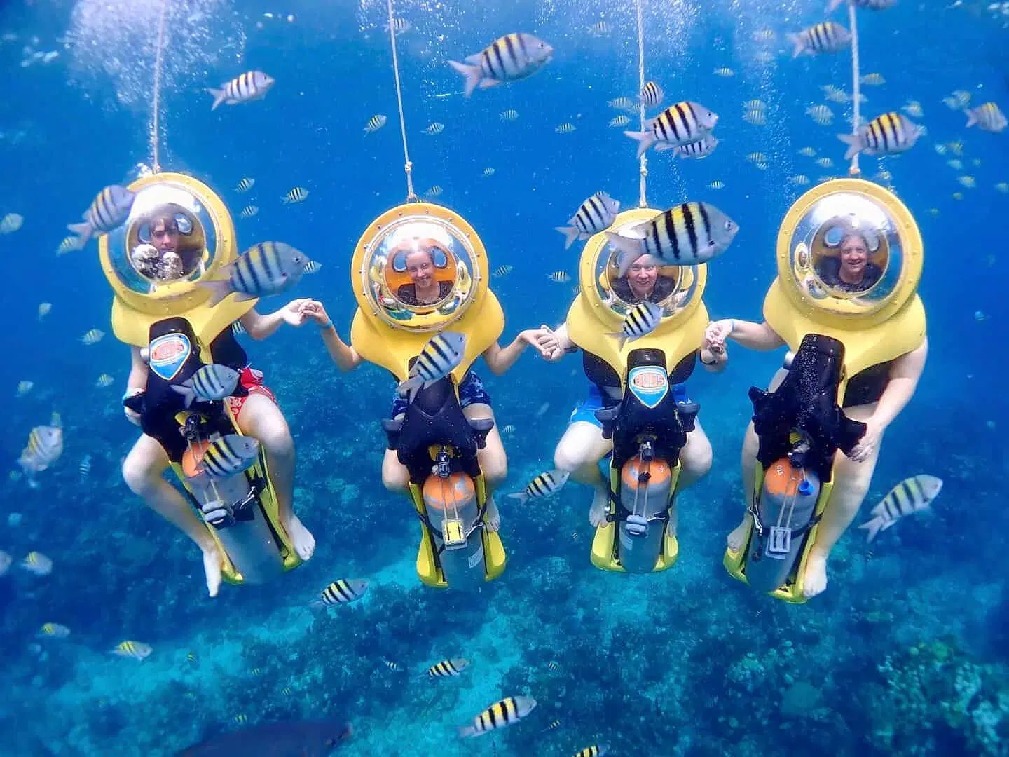 Diver riding a motorised underwater scooter near a reef in Havelock Island