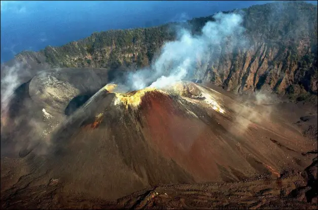 Boat expedition approaching Barren Island, South Asia's only active volcano, Andaman